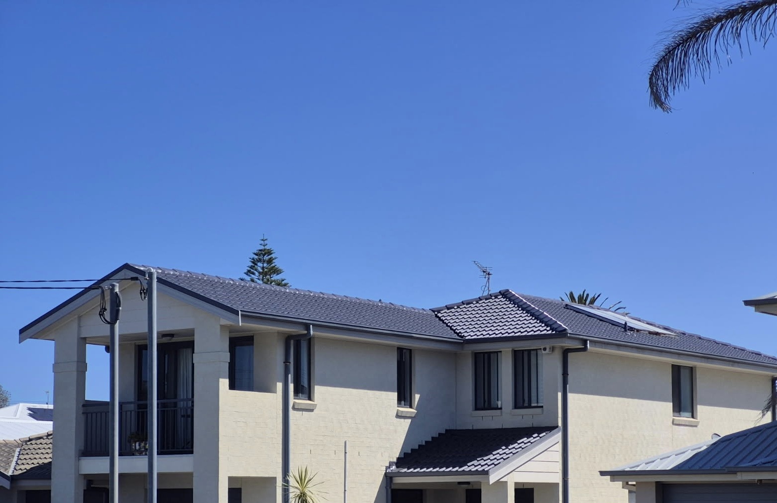 Two storey townhouses finished with a charcoal tile roof
